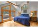 Primary bedroom features hardwood floors, ample natural light and spacious design at 8905 Carol Ln, Conifer, CO 80433