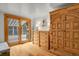 Bedroom featuring wood floors, a walk-out to the deck, and ample storage at 8905 Carol Ln, Conifer, CO 80433