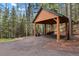 Covered carport provides ample parking and storage at 8905 Carol Ln, Conifer, CO 80433