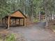 Wood-framed carport provides covered parking near log cabin home at 8905 Carol Ln, Conifer, CO 80433