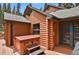 Log cabin features a hot tub on the back deck at 8905 Carol Ln, Conifer, CO 80433
