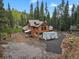 Log cabin nestled on a large lot, surrounded by mature trees offering ample privacy at 8905 Carol Ln, Conifer, CO 80433