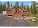 Log cabin features a deck with wooded views at 8905 Carol Ln, Conifer, CO 80433