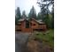 Charming log cabin with a spacious deck and inviting entrance in a wooded setting at 8905 Carol Ln, Conifer, CO 80433