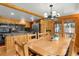 Eat-in kitchen with wood cabinets, granite countertops, stainless appliances, breakfast bar, and sliding door to porch at 8905 Carol Ln, Conifer, CO 80433