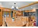 Eat-in kitchen with wood cabinets, granite countertops, stainless appliances, breakfast bar, and open floor plan at 8905 Carol Ln, Conifer, CO 80433