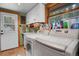 Bright laundry room with storage, window and adjacent to exterior door at 8905 Carol Ln, Conifer, CO 80433
