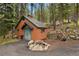 Rustic outbuilding with unique stone accents and outdoor decor at 8905 Carol Ln, Conifer, CO 80433
