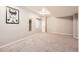 Finished basement features neutral walls, carpet, and picture window at 14245 Corrine Ct, Broomfield, CO 80023
