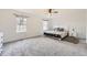 Large bedroom featuring a queen-size bed, plush carpet, and ample natural light from two windows at 14245 Corrine Ct, Broomfield, CO 80023