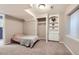 Finished basement bedroom featuring neutral tones, built-in shelving, and closet at 14245 Corrine Ct, Broomfield, CO 80023