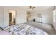 Primary bedroom showcasing soft carpet, a ceiling fan, and an adjacent bathroom and dressing area at 14245 Corrine Ct, Broomfield, CO 80023