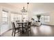 Open dining area with modern chandelier and bay window; part of an open-concept design at 14245 Corrine Ct, Broomfield, CO 80023