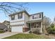 Charming two-story home with a brick-accented porch and attached two-car garage at 14245 Corrine Ct, Broomfield, CO 80023
