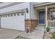 Close-up of the home's front entrance, showcasing the brick accents and covered porch at 14245 Corrine Ct, Broomfield, CO 80023