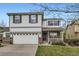 Charming two-story home featuring a well-manicured lawn and attached two car garage at 14245 Corrine Ct, Broomfield, CO 80023