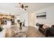 Spacious living room with hardwood floors and an open view into the kitchen and dining area at 14245 Corrine Ct, Broomfield, CO 80023