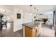 Open-concept kitchen island transitions into the living room with a fireplace and plenty of natural light at 14245 Corrine Ct, Broomfield, CO 80023