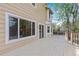 Backyard wooden deck with ample space for outdoor seating, featuring a sliding glass door and sunlit windows at 17519 E Caspian Pl, Aurora, CO 80013