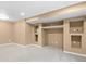 Finished basement featuring built-in shelving and a carpeted floor at 17519 E Caspian Pl, Aurora, CO 80013
