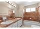 Bathroom boasts double sinks, marble-like tile, and a soaking tub at 17519 E Caspian Pl, Aurora, CO 80013