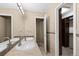 Bathroom featuring double sinks, tile backsplash, and access to a walk-in closet for added convenience at 17519 E Caspian Pl, Aurora, CO 80013