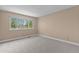 Bright bedroom features plush carpeting and a large window with tree views at 17519 E Caspian Pl, Aurora, CO 80013