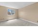 Cozy bedroom featuring a large window with natural light and neutral carpet that provides a peaceful retreat at 17519 E Caspian Pl, Aurora, CO 80013