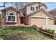 Charming home exterior with brick accents, a well-maintained lawn, and an attached two-car garage at 17519 E Caspian Pl, Aurora, CO 80013