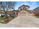 Two-story home with a manicured lawn and an attached two-car garage, creating a welcoming curb appeal at 17519 E Caspian Pl, Aurora, CO 80013