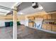 Spacious garage featuring ample storage, shelving and cabinets, a convenient entry and work space at 17519 E Caspian Pl, Aurora, CO 80013