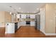 Spacious kitchen with stainless steel appliances, white cabinets, granite counters, and hardwood flooring at 17519 E Caspian Pl, Aurora, CO 80013