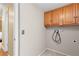 Functional laundry room with overhead cabinets and ample space for laundry appliances, perfect for chores at 17519 E Caspian Pl, Aurora, CO 80013