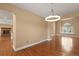 Open living area showcasing hardwood floors and a view into a cozy living room with a fireplace at 17519 E Caspian Pl, Aurora, CO 80013