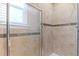 Well-appointed shower with glass door and elegant tile work for a luxurious and convenient bathing experience at 17519 E Caspian Pl, Aurora, CO 80013