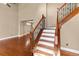 Inviting staircase with wood treads, white risers, and decorative metal spindles leading to the upper level at 17519 E Caspian Pl, Aurora, CO 80013