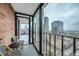 City views from a stylish condo balcony with seating and brick accents, creating an inviting outdoor space at 1551 Larimer St # 1901, Denver, CO 80202