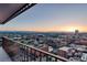 Balcony view overlooking the city at sunset, showcasing the vibrant urban skyline and distant mountains at 1551 Larimer St # 1901, Denver, CO 80202