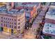 An elevated shot of a street that is lined with buildings and colorful flags strung across the road at 1551 Larimer St # 1901, Denver, CO 80202