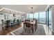 A modern dining room features hardwood floors, an open kitchen, and floor-to-ceiling windows with city views at 1551 Larimer St # 1901, Denver, CO 80202