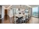A spacious kitchen with hardwood floors features an island with counter seating and stainless steel appliances at 1551 Larimer St # 1901, Denver, CO 80202