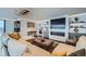 Comfortable living room with sleek built-ins, including a fireplace, and soft, modern lighting at 1551 Larimer St # 1901, Denver, CO 80202