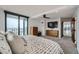 Large main bedroom with balcony access features a ceiling fan, dresser, and city views at 1551 Larimer St # 1901, Denver, CO 80202