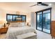 A luxurious bedroom has a king bed, bench, and large windows overlooking the city at 1551 Larimer St # 1901, Denver, CO 80202