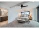 Bright bedroom with ceiling fan, king bed, and bench features an ensuite bathroom and city views at 1551 Larimer St # 1901, Denver, CO 80202