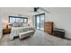 The main bedroom features a king bed, balcony access, and a modern ceiling fan at 1551 Larimer St # 1901, Denver, CO 80202