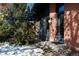 House exterior with brick facade and snowy landscaping at 7117 Glacier View Rd, Longmont, CO 80503