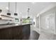 Finished basement with a stylish wet bar, floating shelves, and modern pendant lighting at 2665 Juilliard St, Boulder, CO 80305