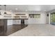 Basement area with a wet bar, wine fridge, floating shelves, and large window at 2665 Juilliard St, Boulder, CO 80305