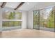 Light-filled bedroom with exposed beams and a scenic view from the large windows and access to the balcony at 2665 Juilliard St, Boulder, CO 80305